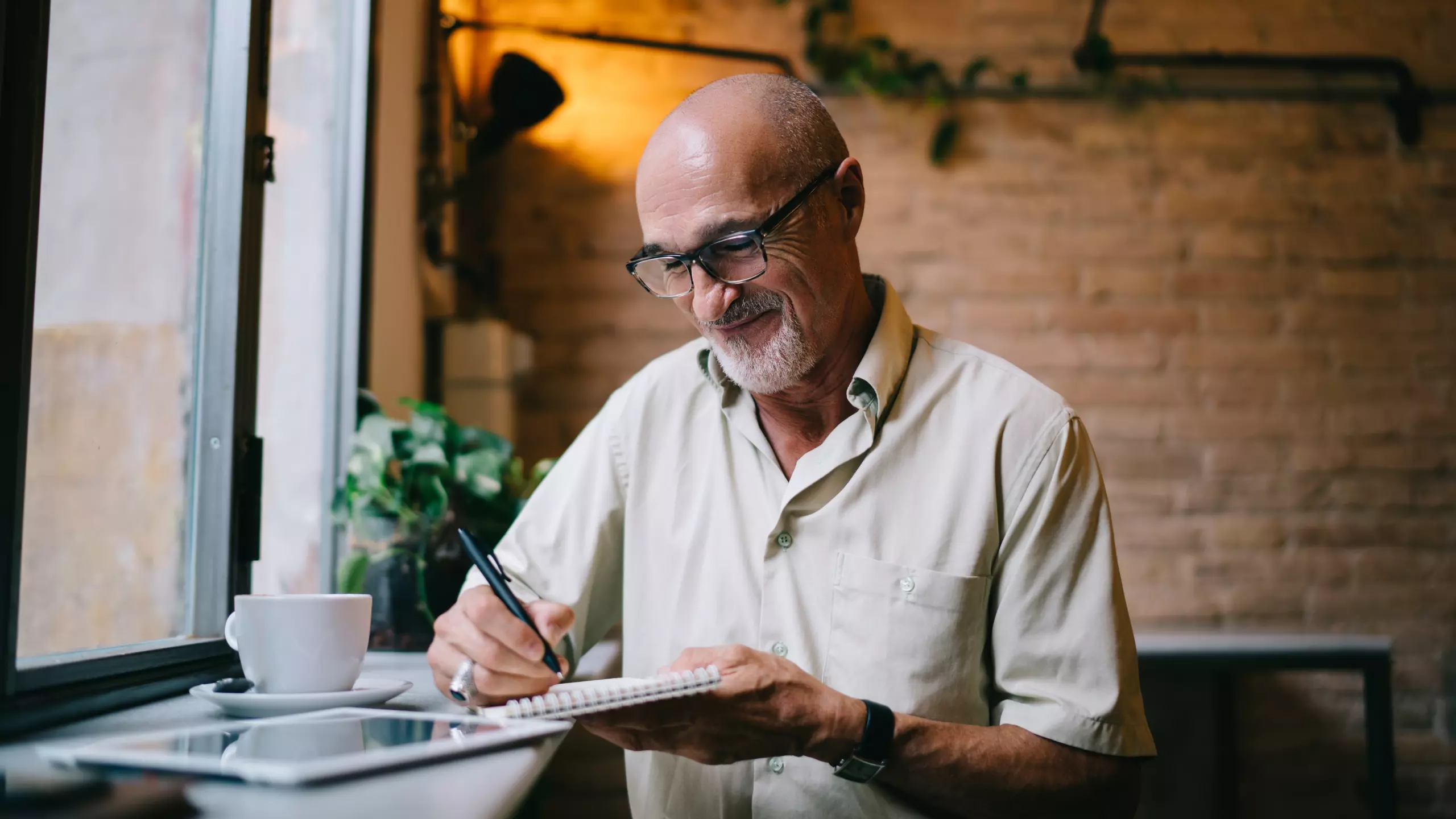 male writing down retirement plans
